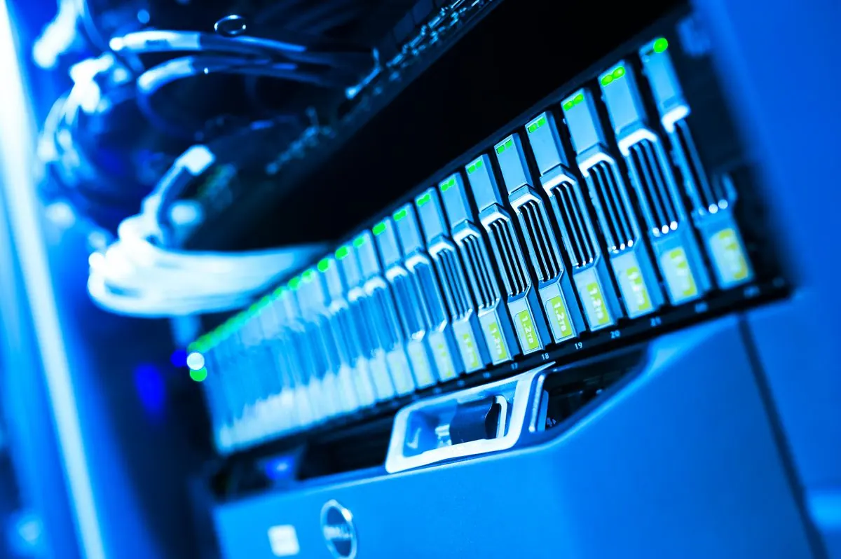Close-up of blue-lit computer server hardware representing cloud infrastructure