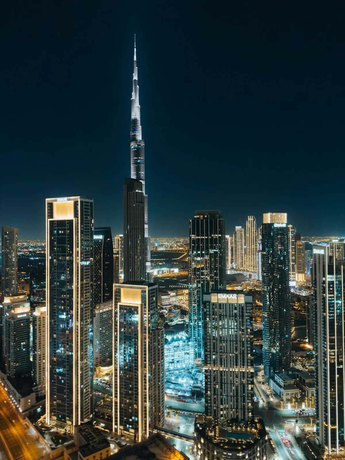 Night view of Dubai's downtown skyline from a high-rise rooftop
