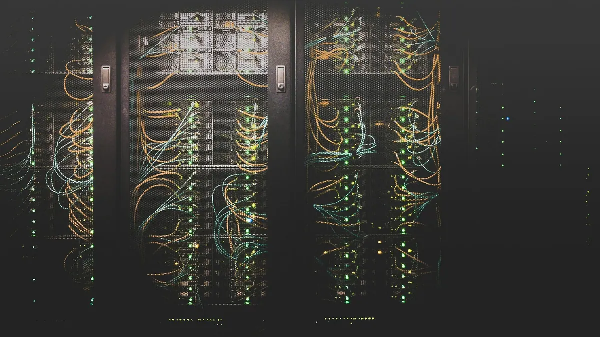 Rack of servers in a data center room with blue ambient lighting